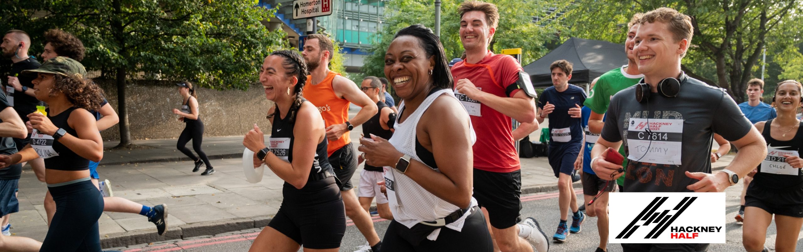 Hackney Half participants running the Hackney Half Marathon. They are smiling as they run. We hope that you will run the Hackney Half Marathon for Get KIds Going!
